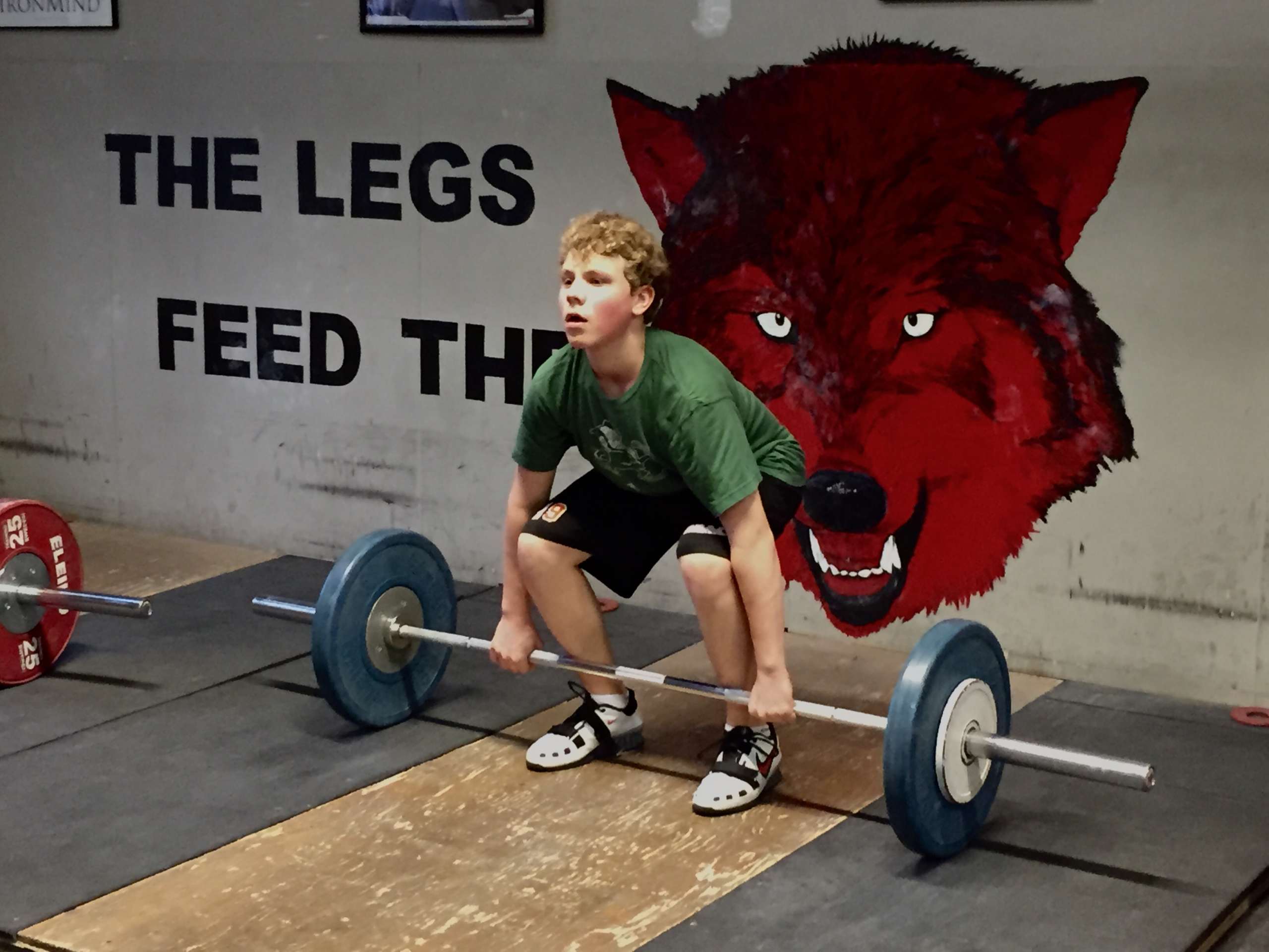 A young boy about to lift weight