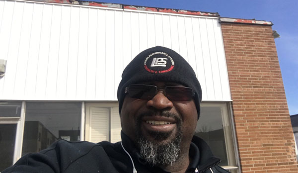 A selfie photo of Clance Laylor in front of the LPS facility.