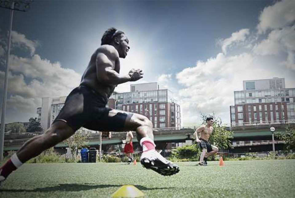 A photo of an athlete doing sprint in the field.