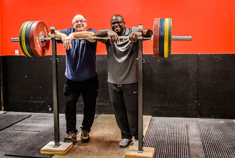 Pierre Roy and Clance Laylor teaching weightlifting